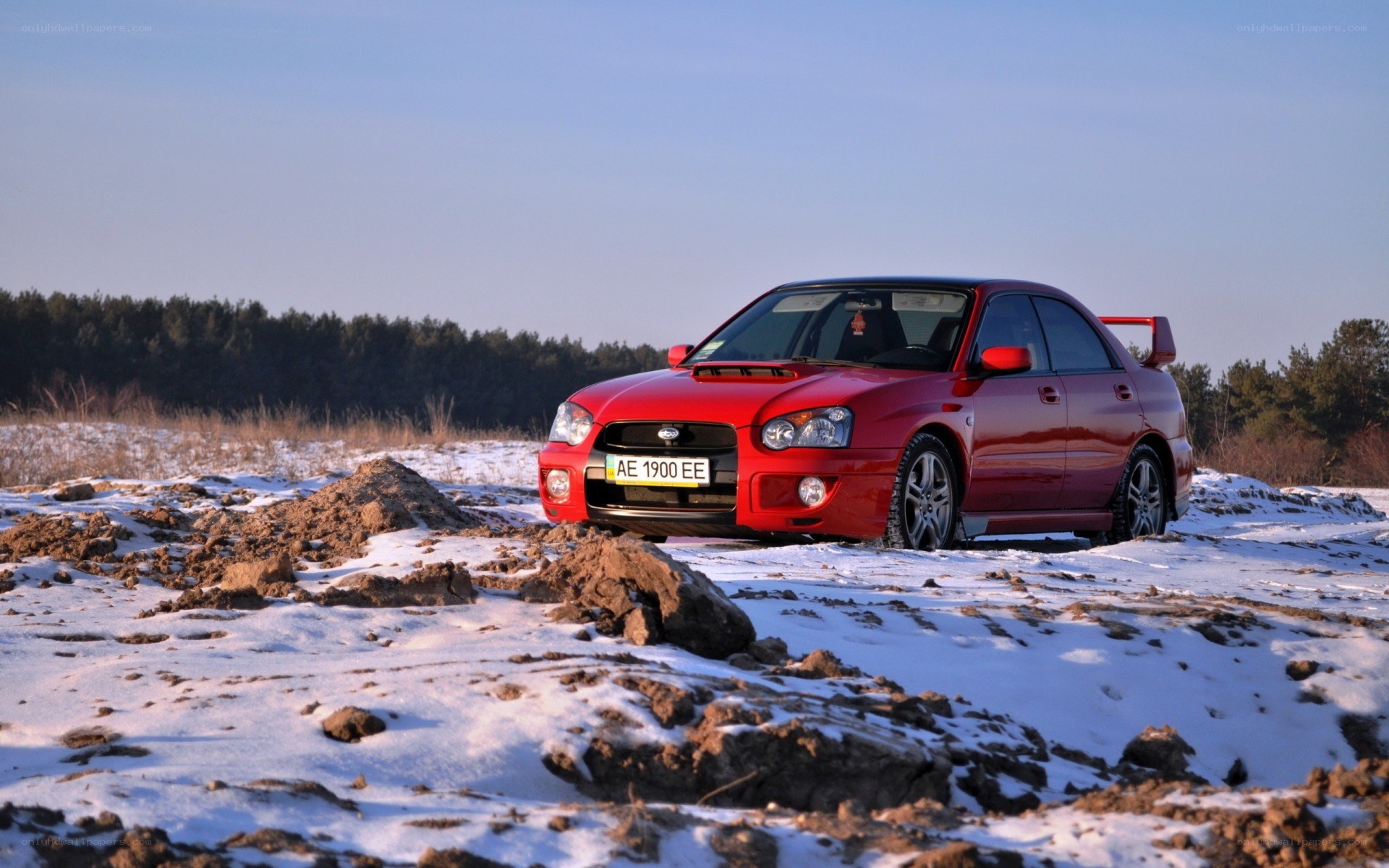 Red car on snowy field