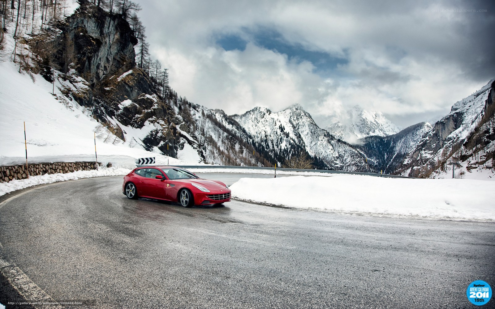 Red car on snowy mountain road
