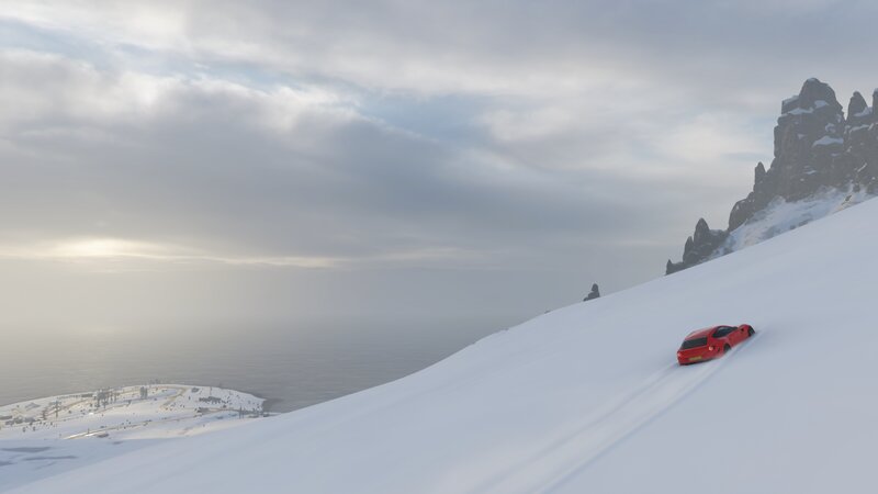 Red Car on Snowy Slope