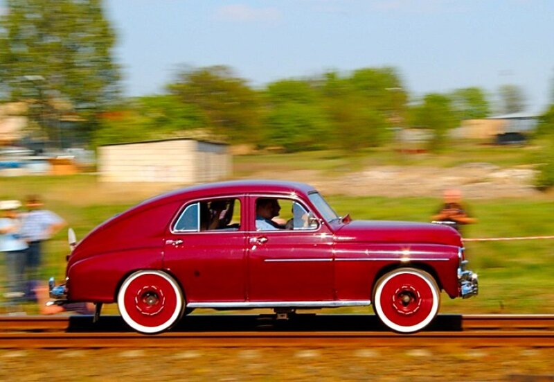 Red car on train tracks