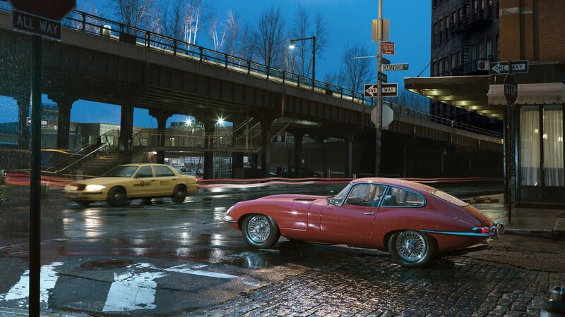 Red car on wet city street