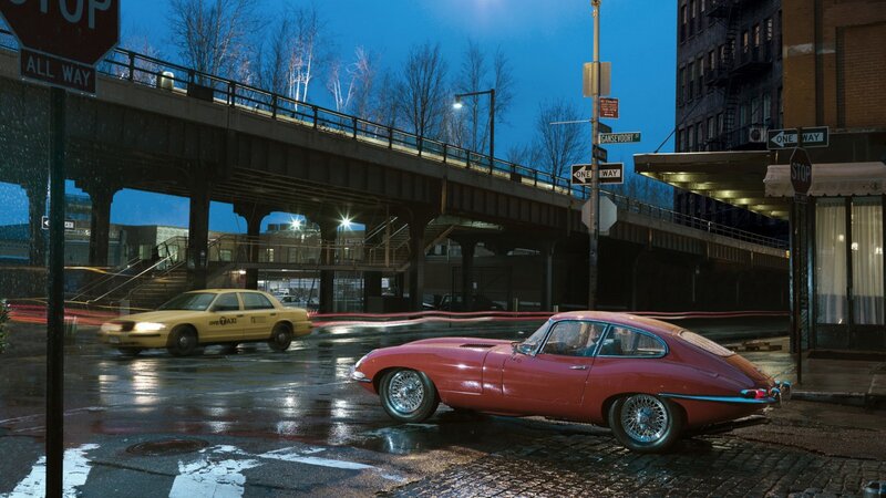 Red car on wet city street
