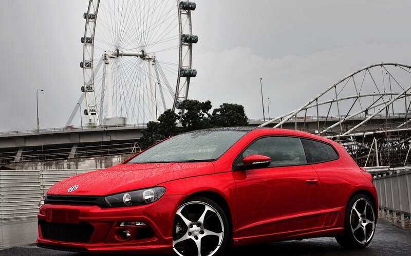 Red Car on Wet Pavement — Overcast