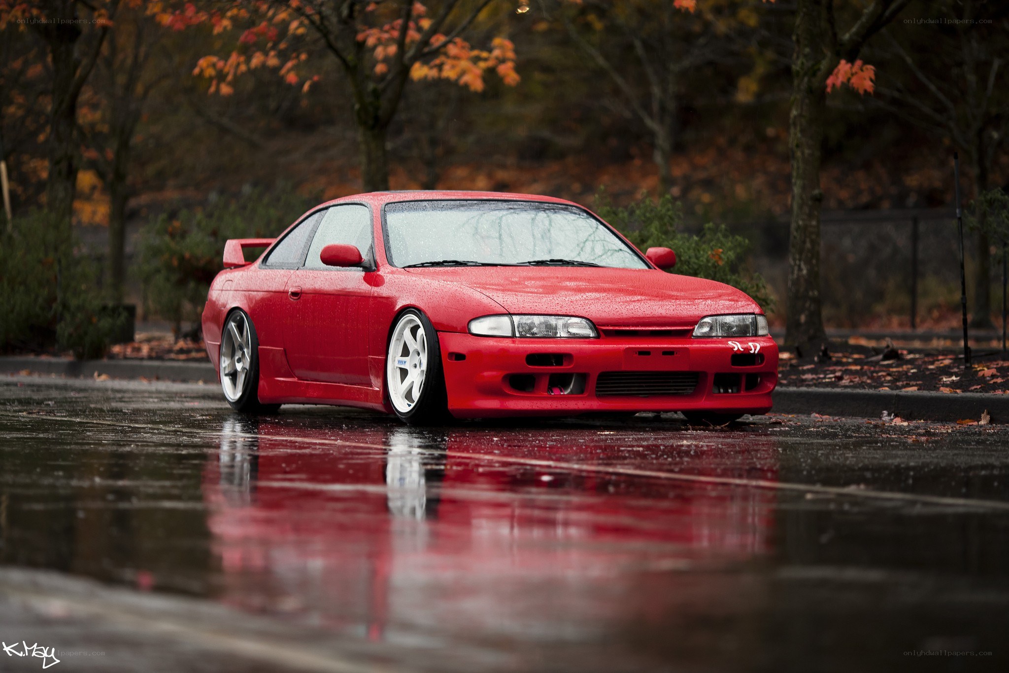 Red car on wet pavement