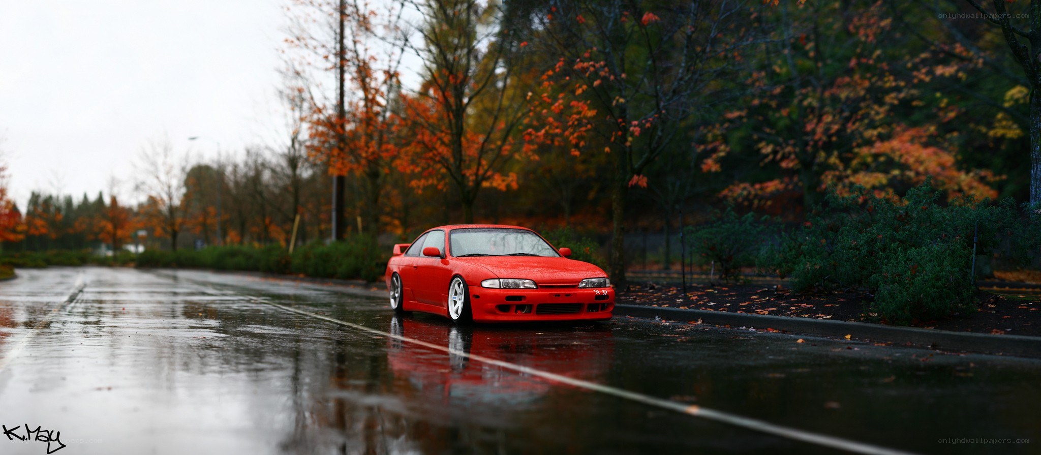 Red car on wet road