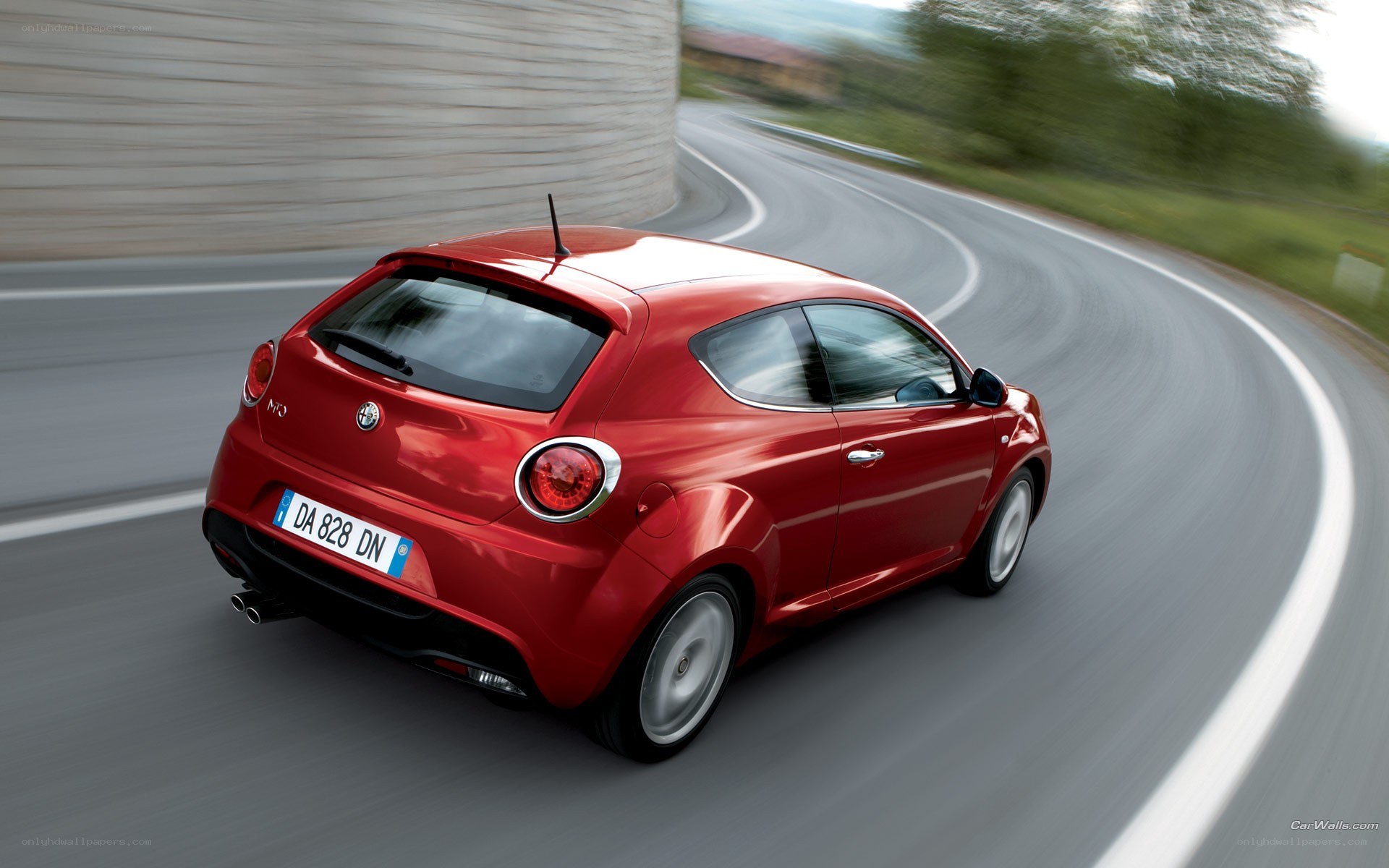 red car on winding road