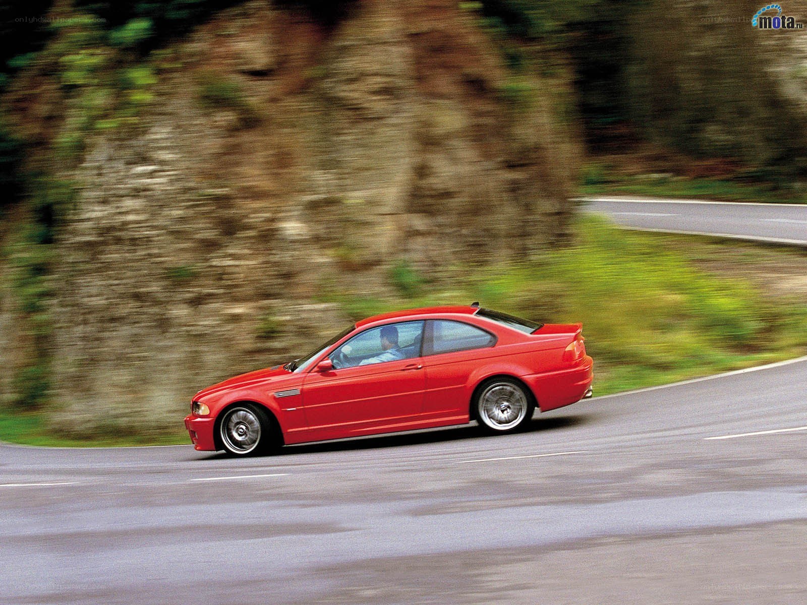 red car on winding road