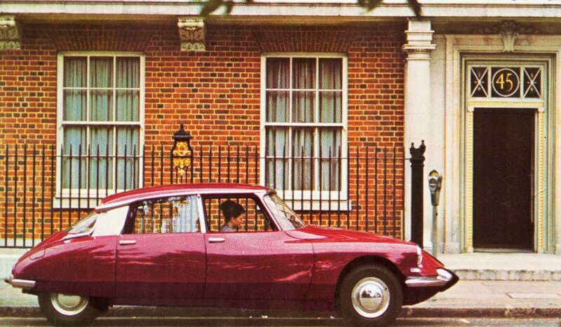 Red car parked in front of brick building