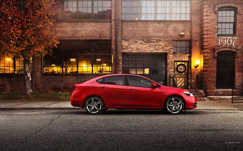 Red car parked in front of brick building