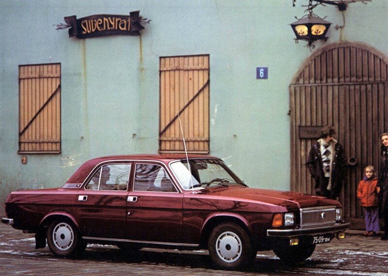 Red car parked in front of building