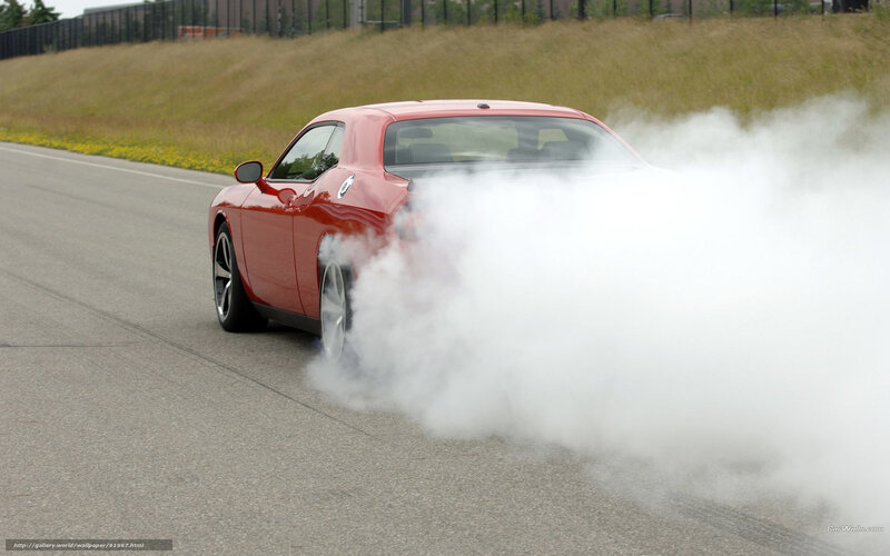 Red car performing burnout