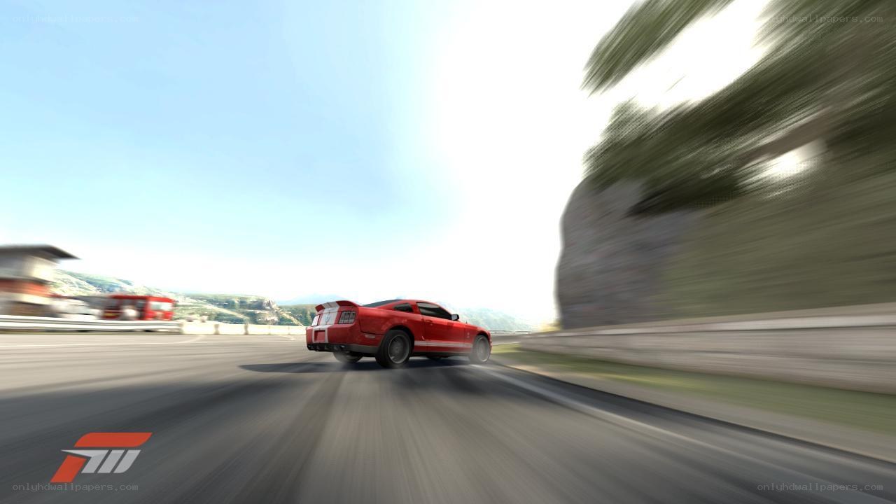 Red car racing on a road