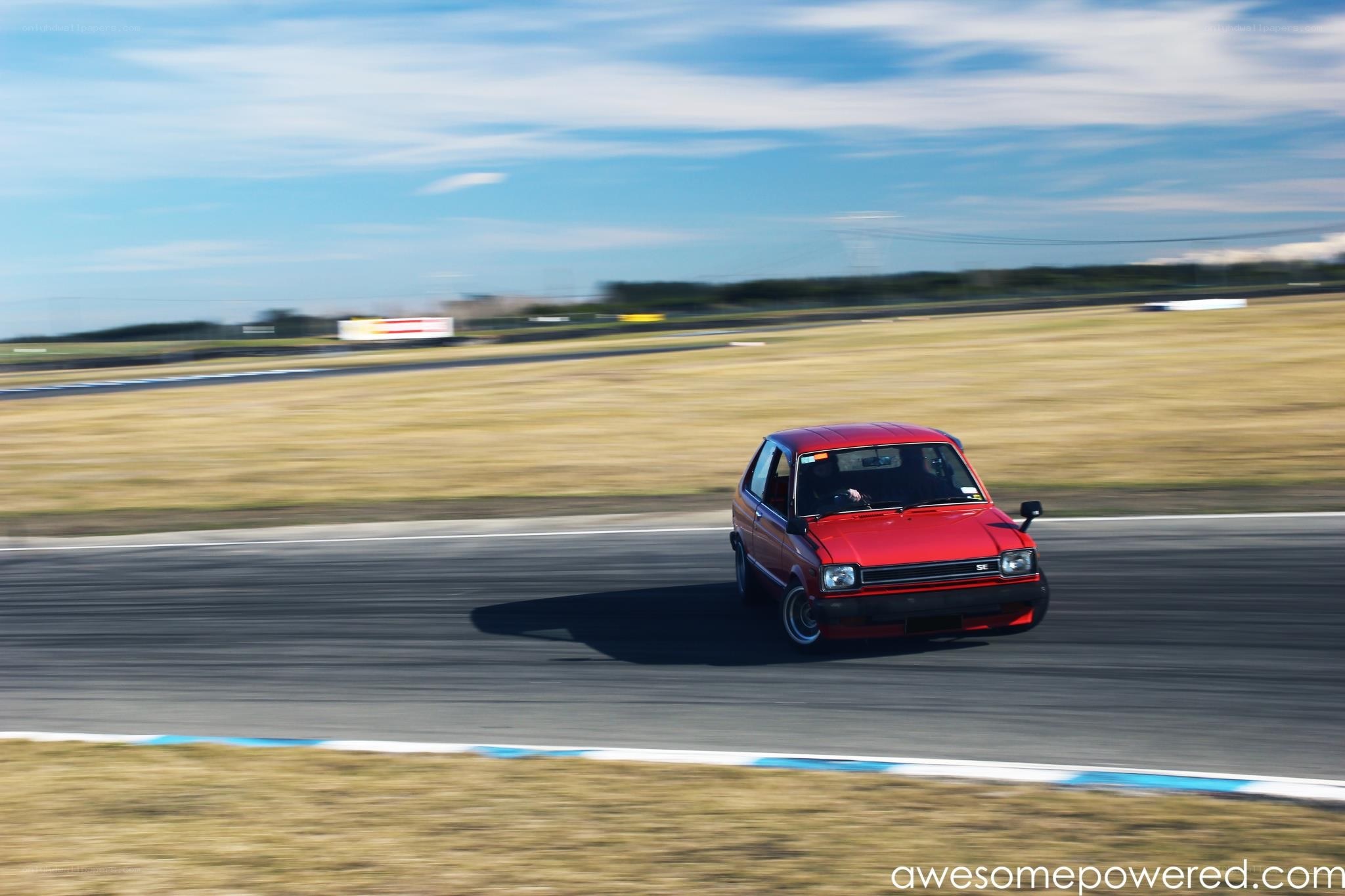 Red car racing on track