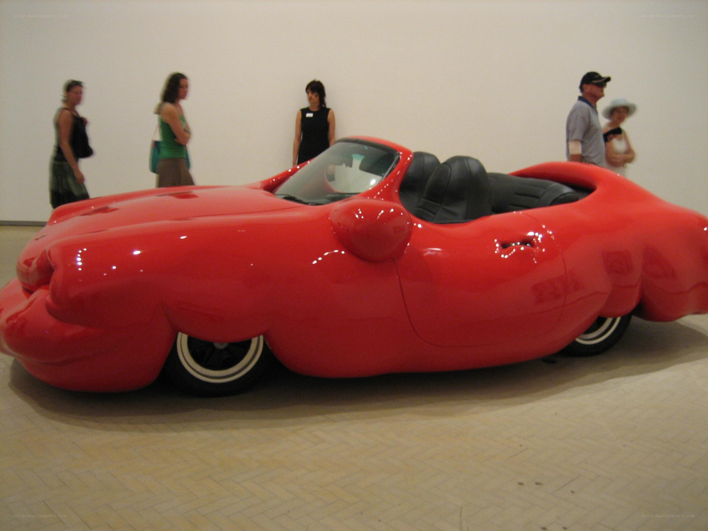 Red car sculpture in gallery