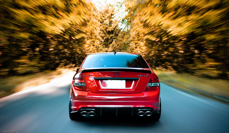 Red car speeding on road