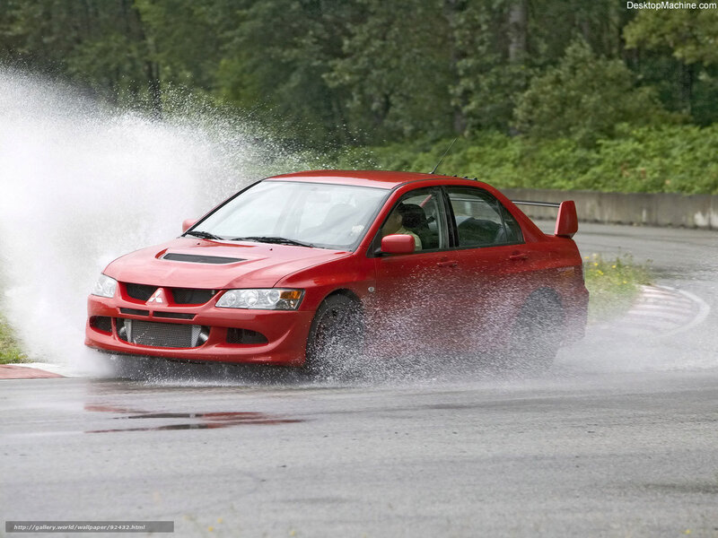 Red car splashing water on track