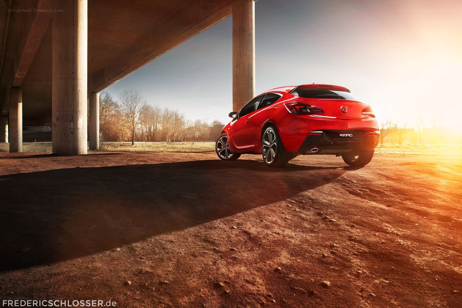 Red car under a bridge