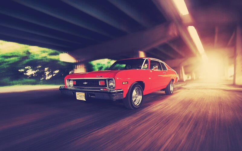 Red car under overpass