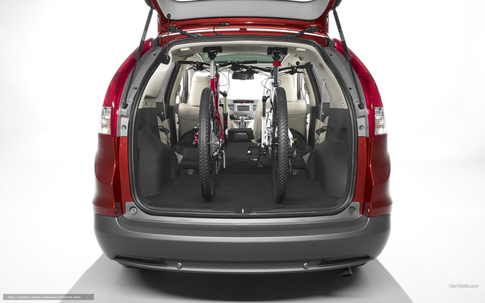 Red car with bicycles in trunk