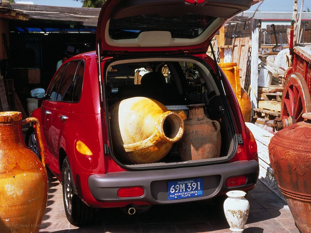 Red car with large pots in trunk