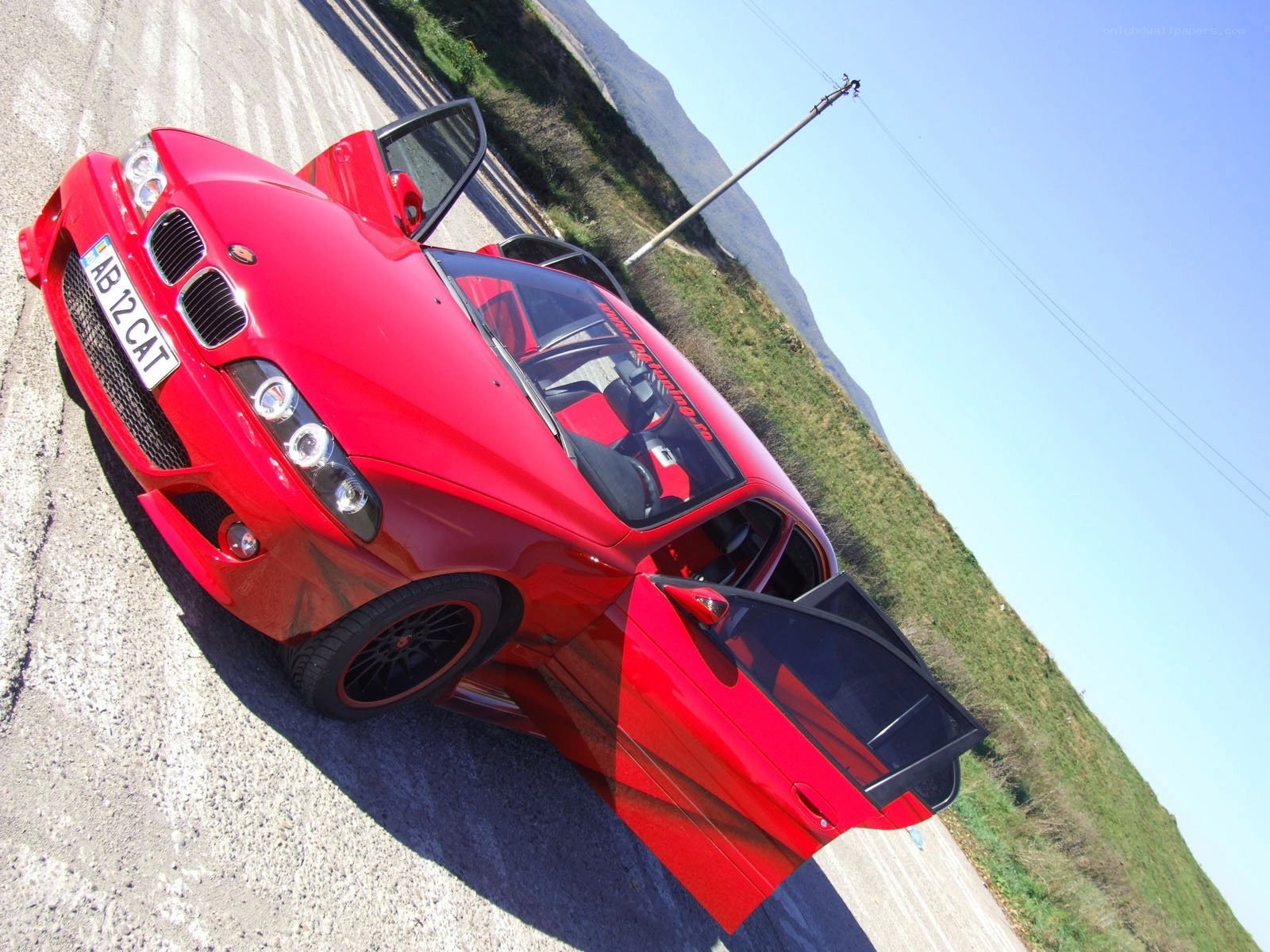 Red car with open doors