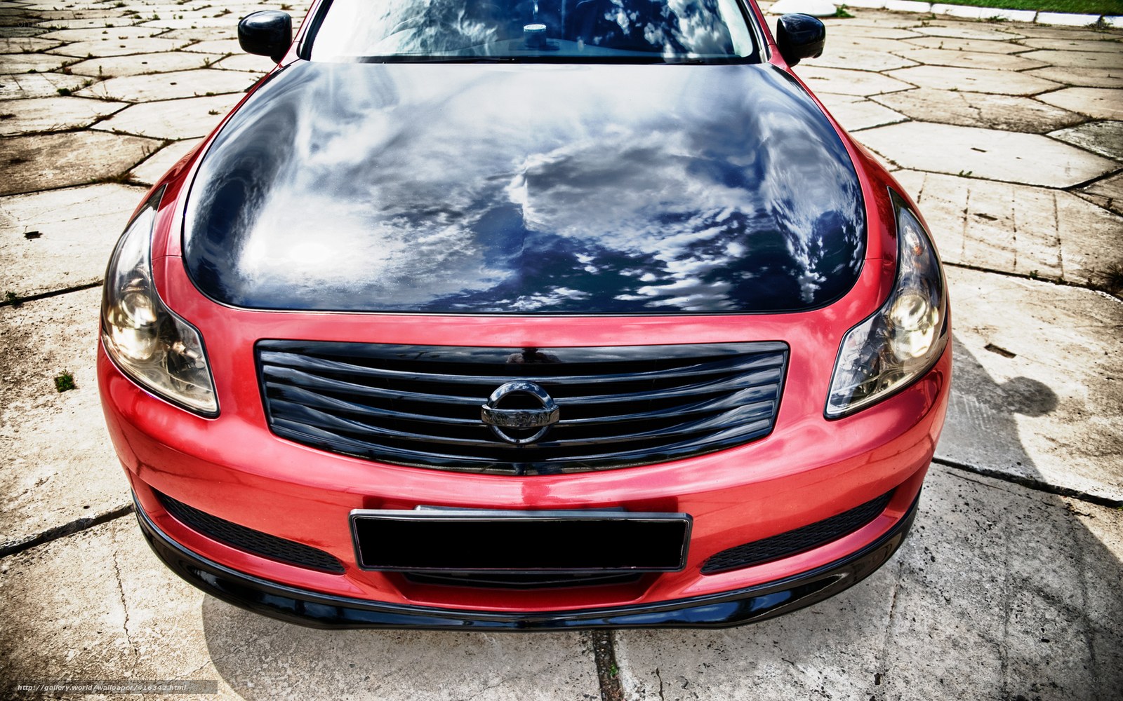 Red car with sky reflection