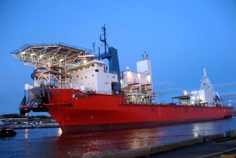 Red cargo ship at dock
