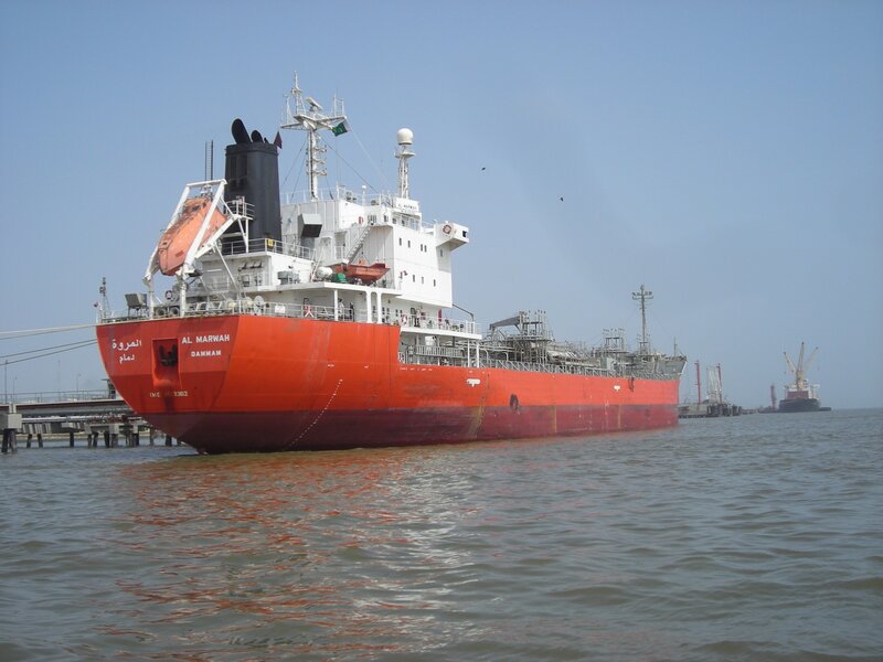 Red cargo ship at port