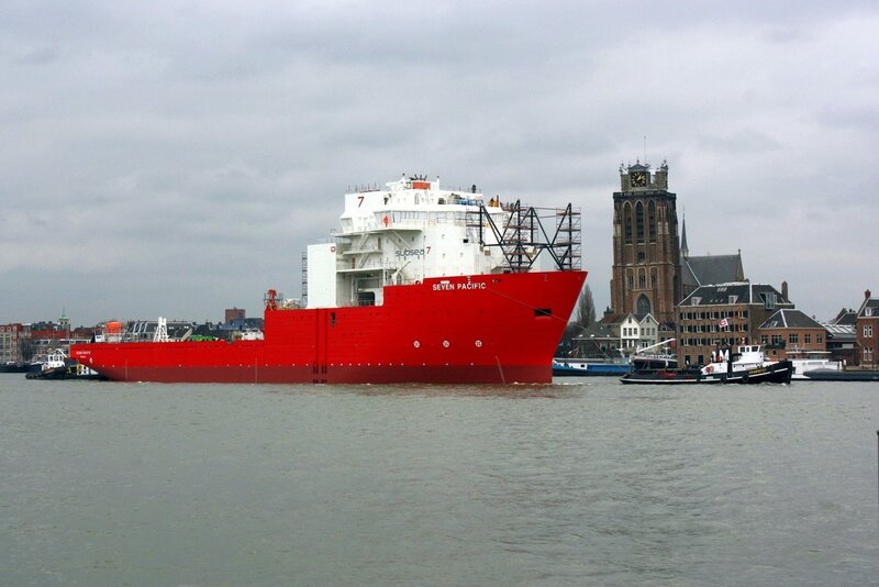 Red cargo ship in harbor