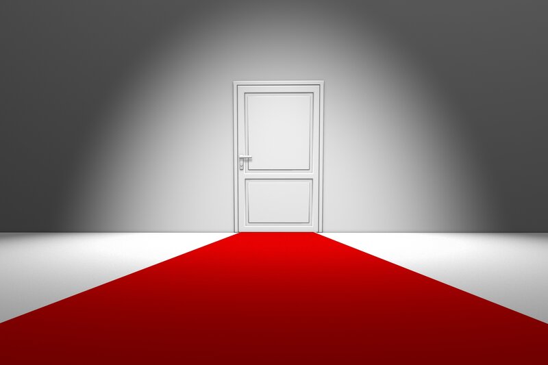 red carpet leading to white door