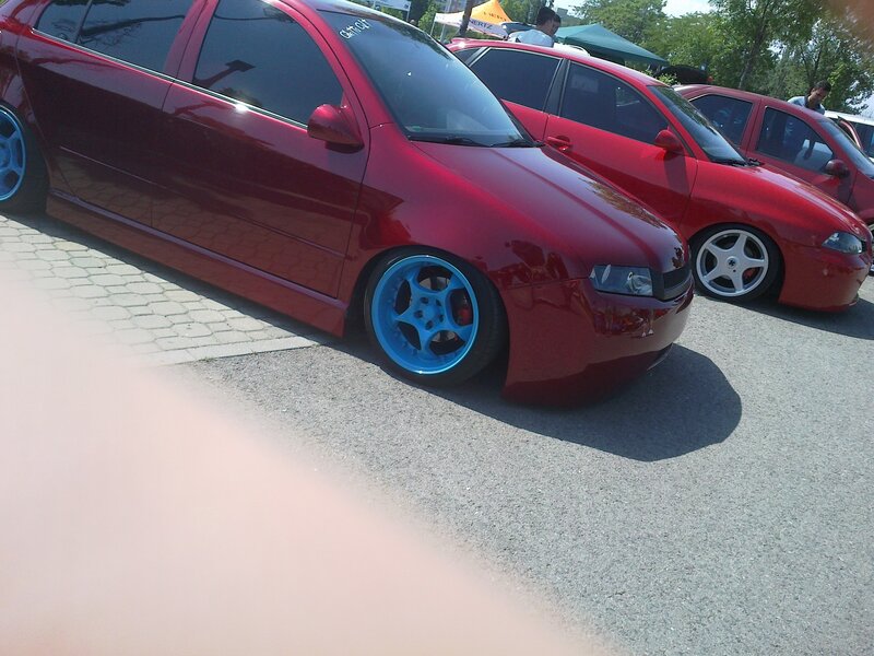 Red cars at a car show