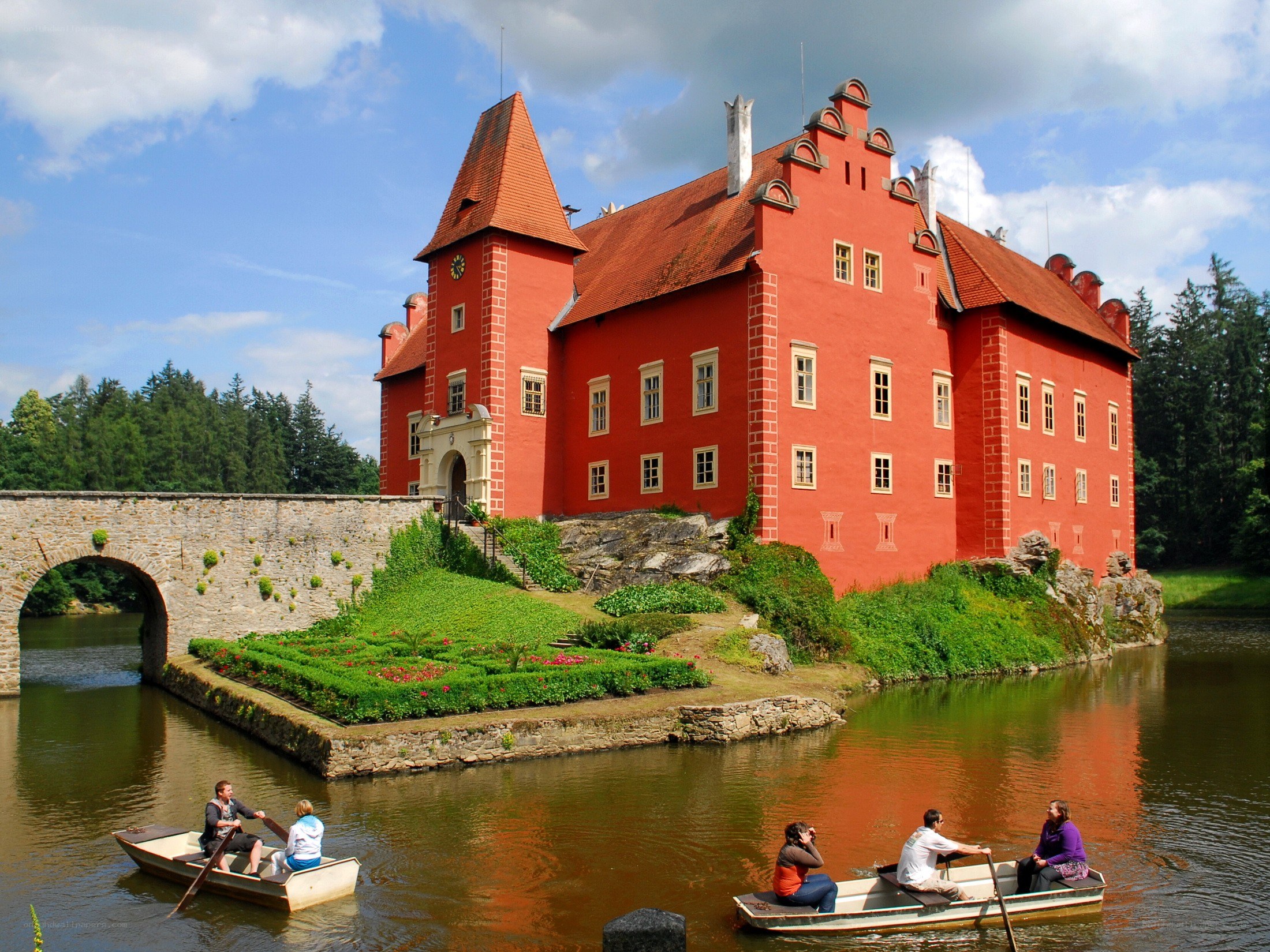 Red castle with boats on a river