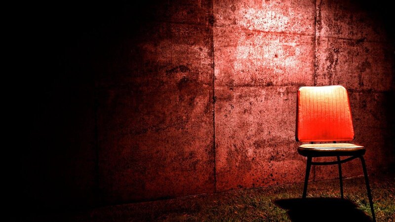 Red Chair in Dark Room