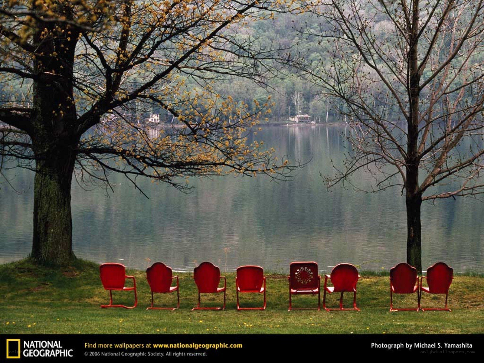 Red chairs by a lake