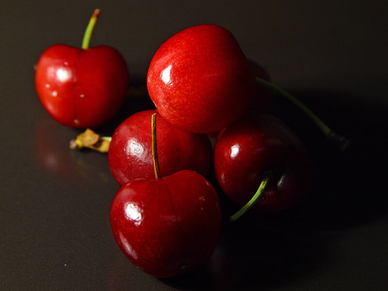 Red cherries on dark surface