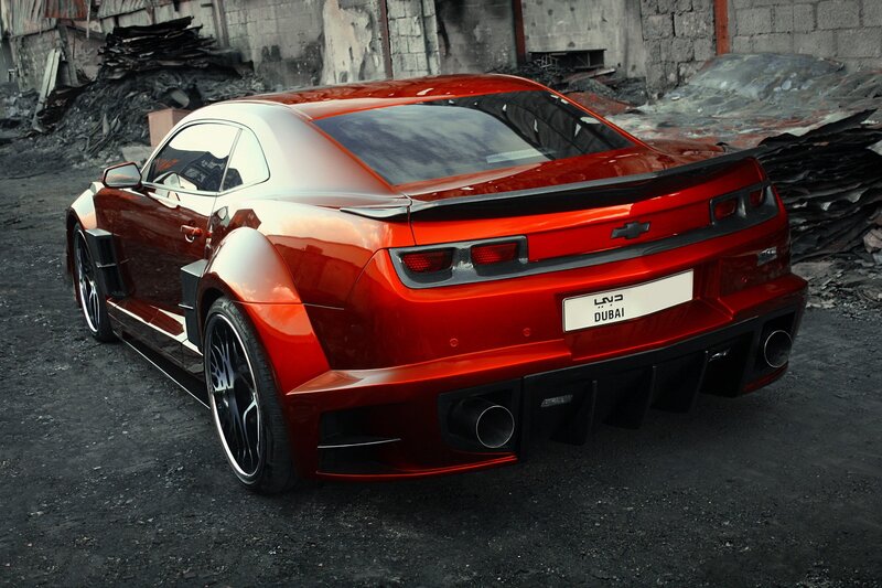 Red Chevrolet Camaro in industrial setting