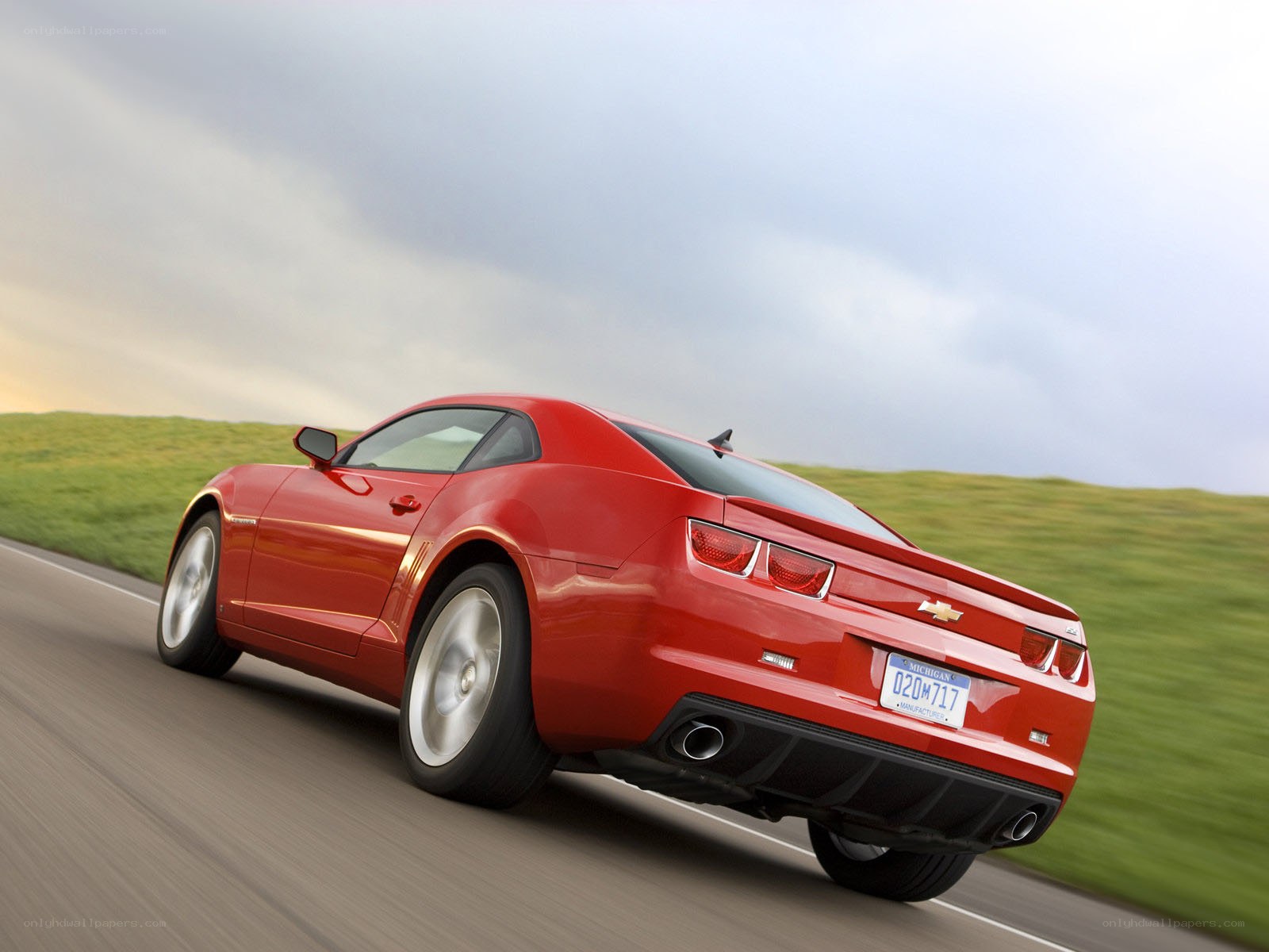 Red Chevrolet Camaro in motion