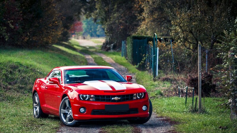 Red Chevrolet Camaro on a country road