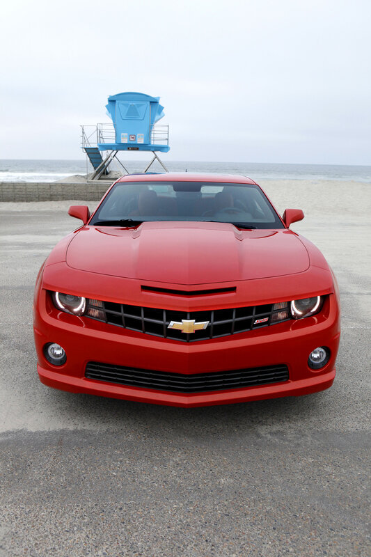 Red Chevrolet Camaro on beach