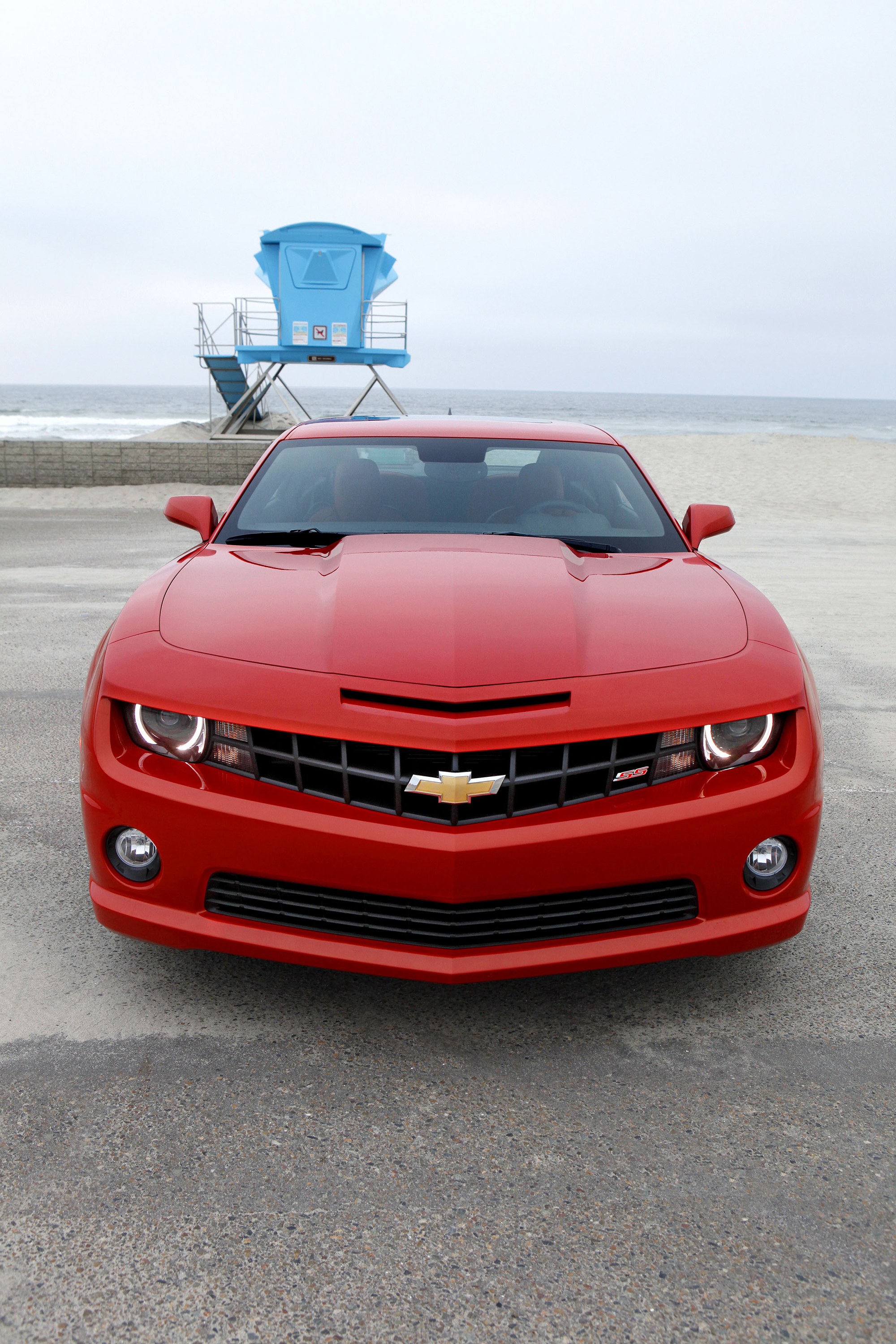 Red Chevrolet Camaro on beach