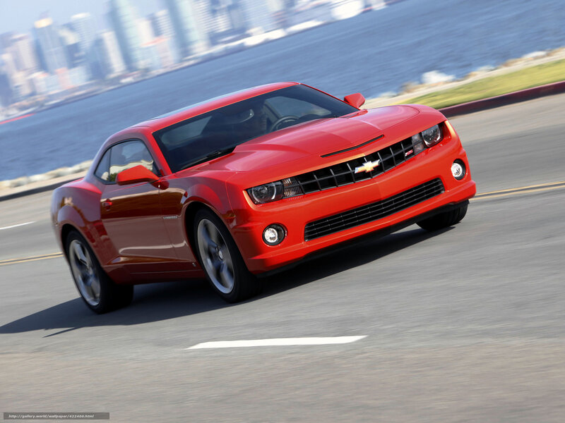 Red Chevrolet Camaro on coastal road