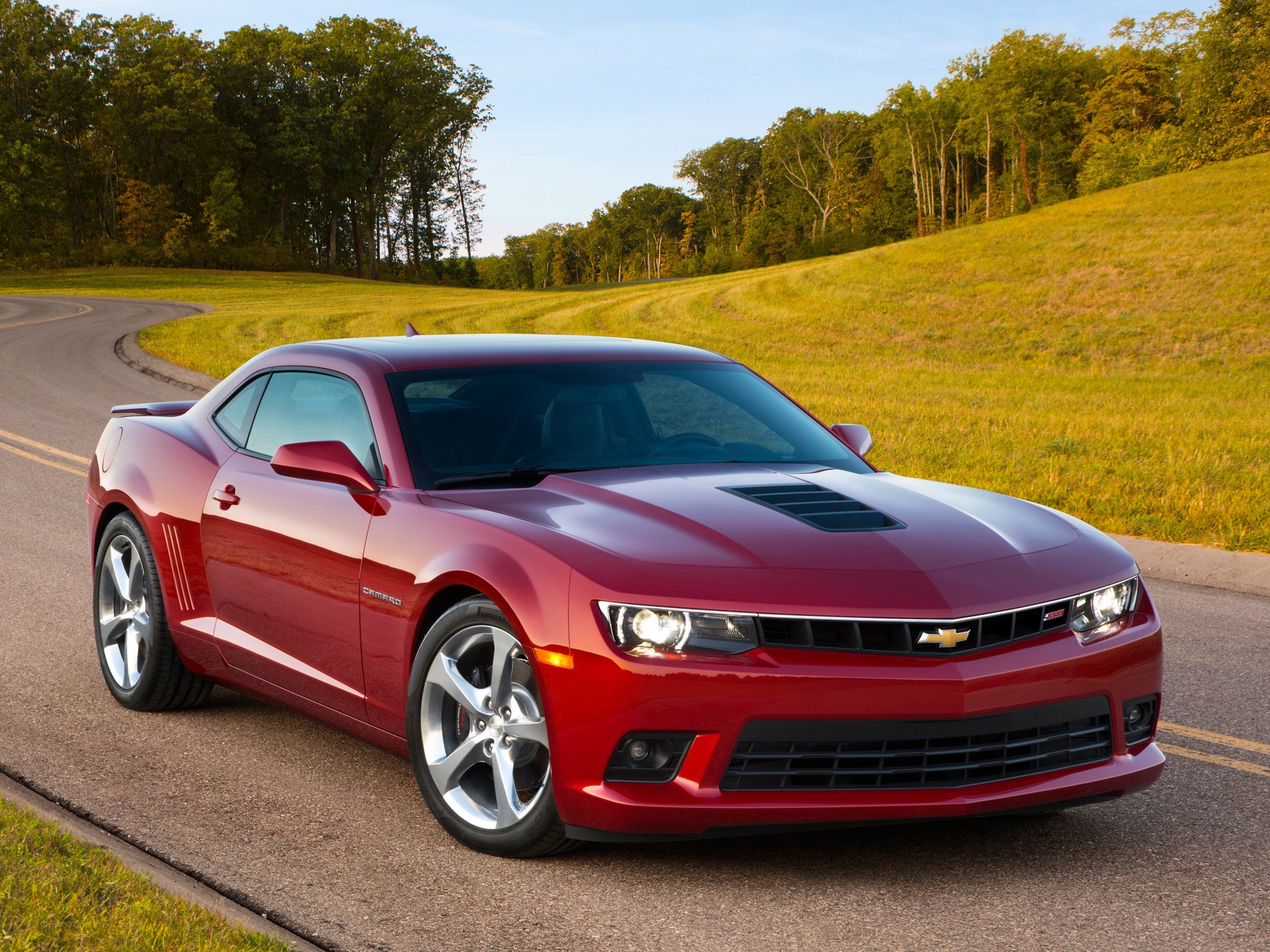 Red Chevrolet Camaro on country road