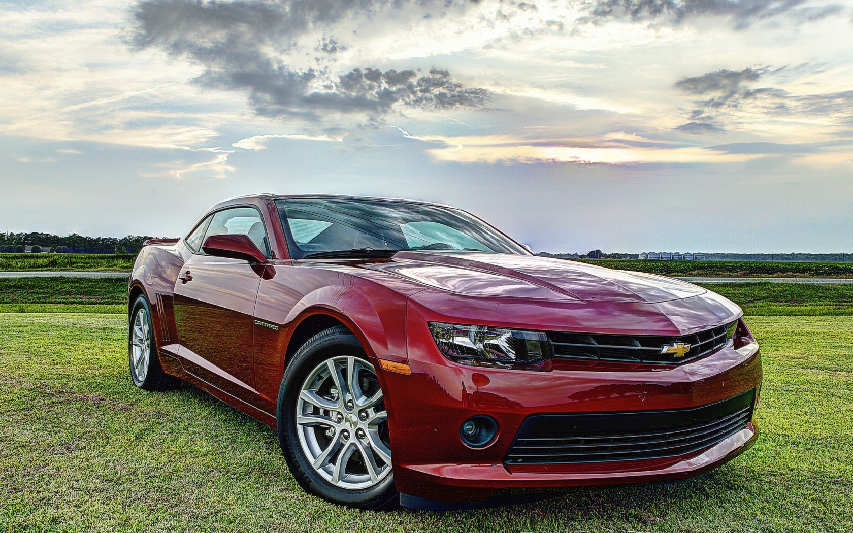 Red Chevrolet Camaro on grass