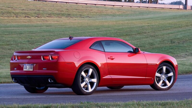 Red Chevrolet Camaro on road