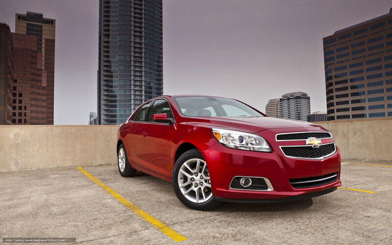 Red Chevrolet Malibu in city parking