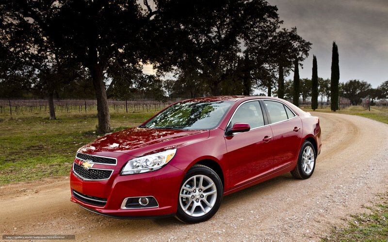 Red Chevrolet Malibu on a dirt road