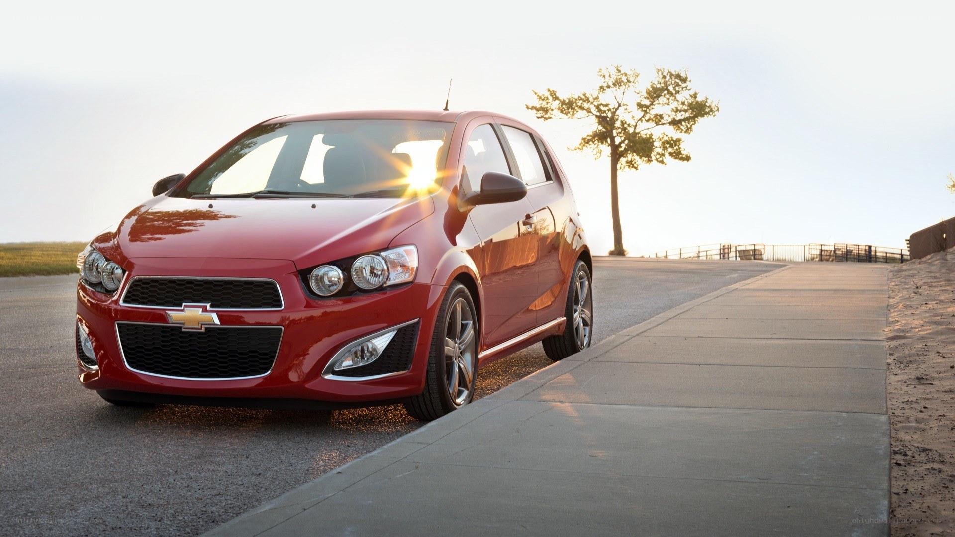 Red Chevrolet Sonic on a road