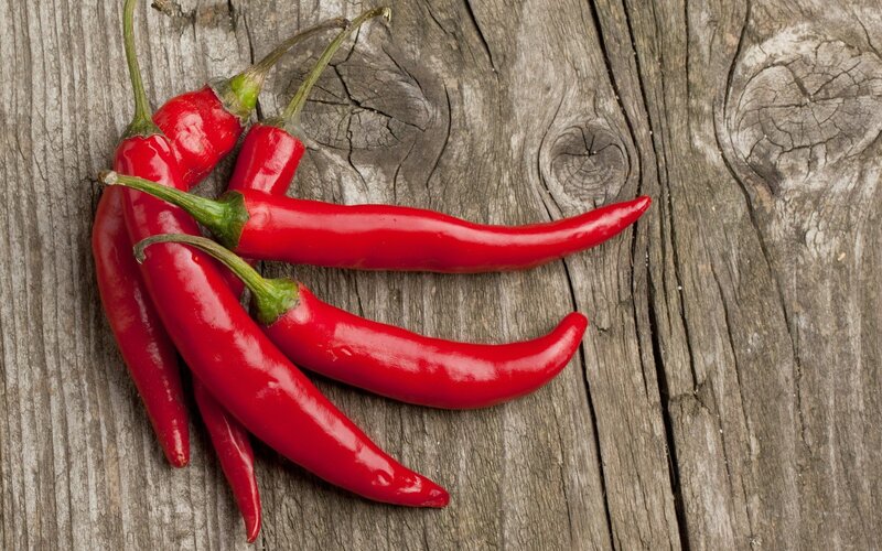 Red chili peppers on wood