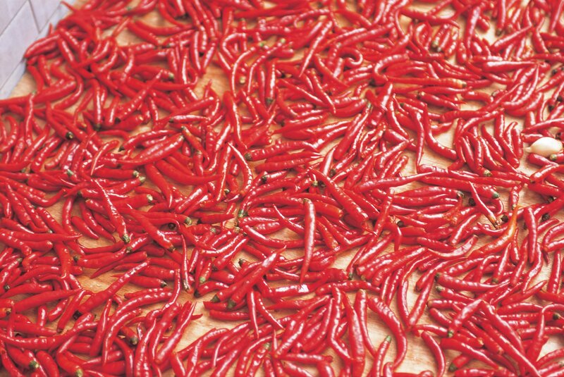 Red chili peppers on wooden surface