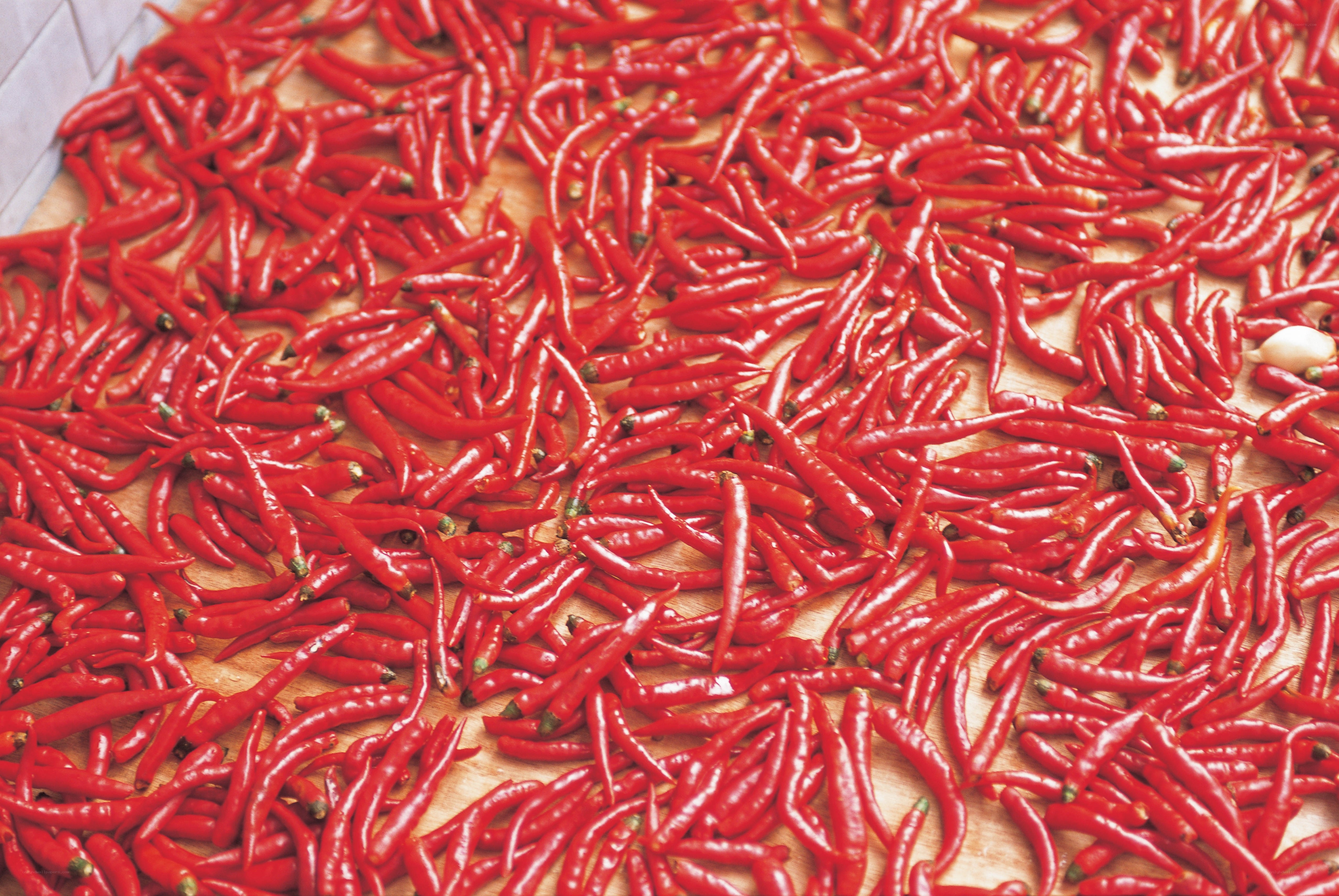 Red chili peppers on wooden surface